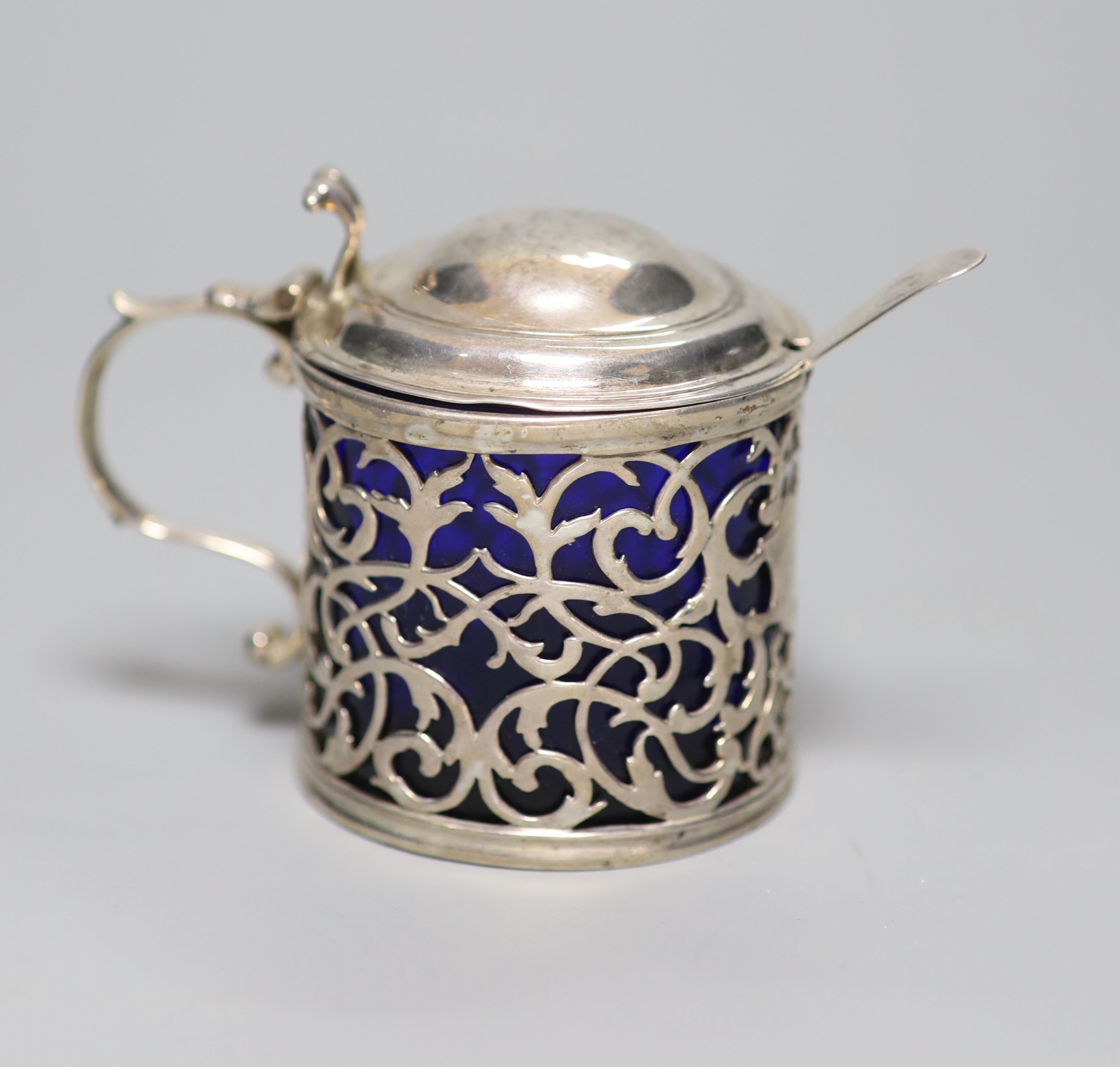 A George III pierced silver drum mustard, London, 1767, (a.f.) with blue glass liner